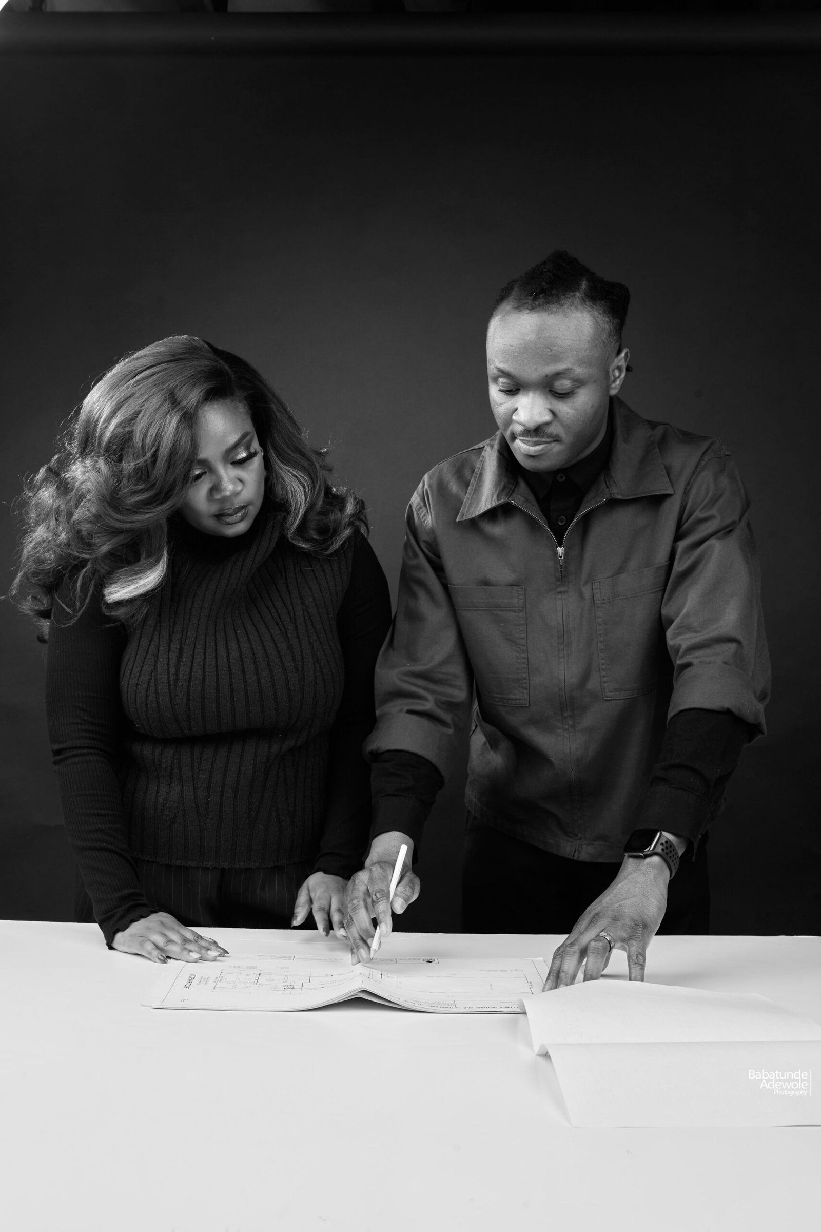 REPLACE: Team adjusting lighting and details during setup - behind the scenes on-site